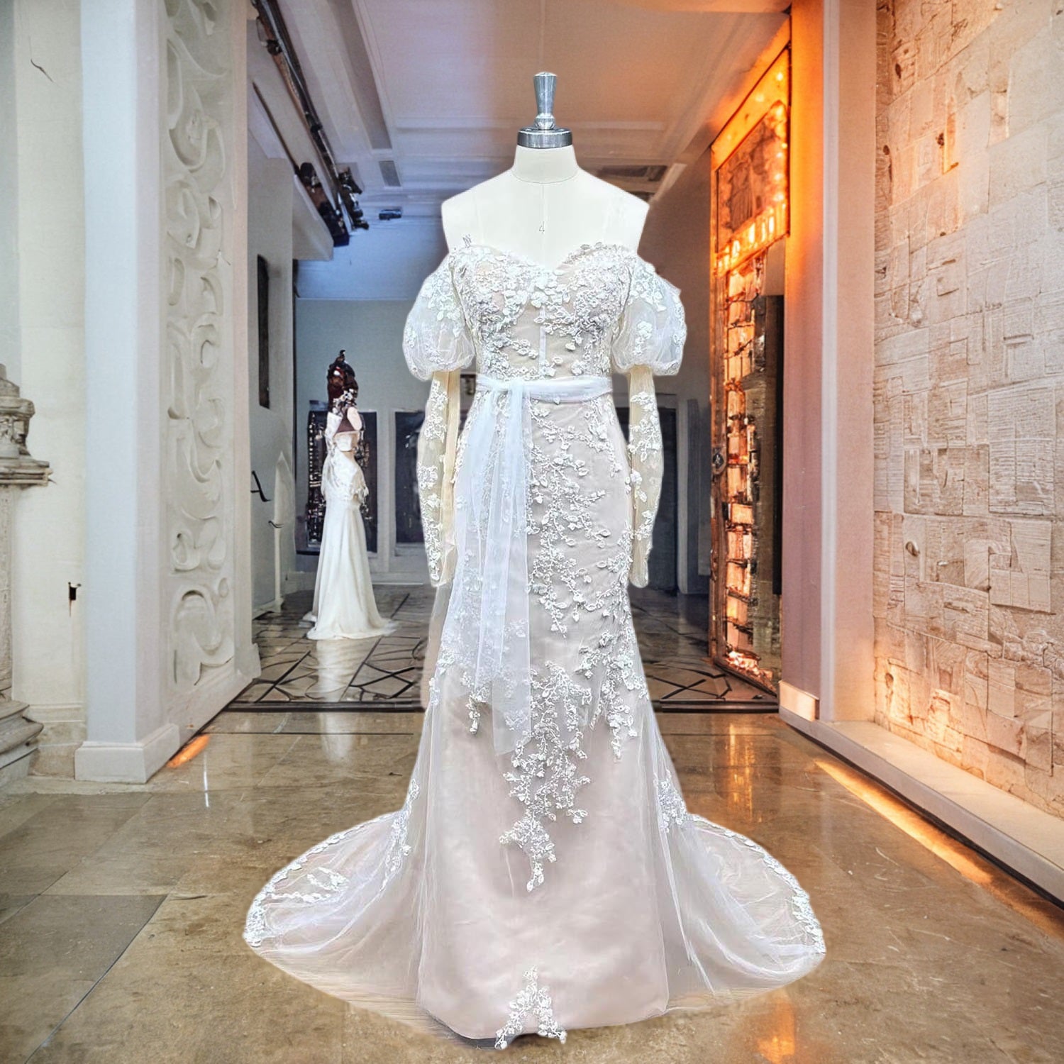 Full-length front display of an ivory off-the-shoulder long sleeve lace mermaid wedding dress on a boutique showroom mannequin.