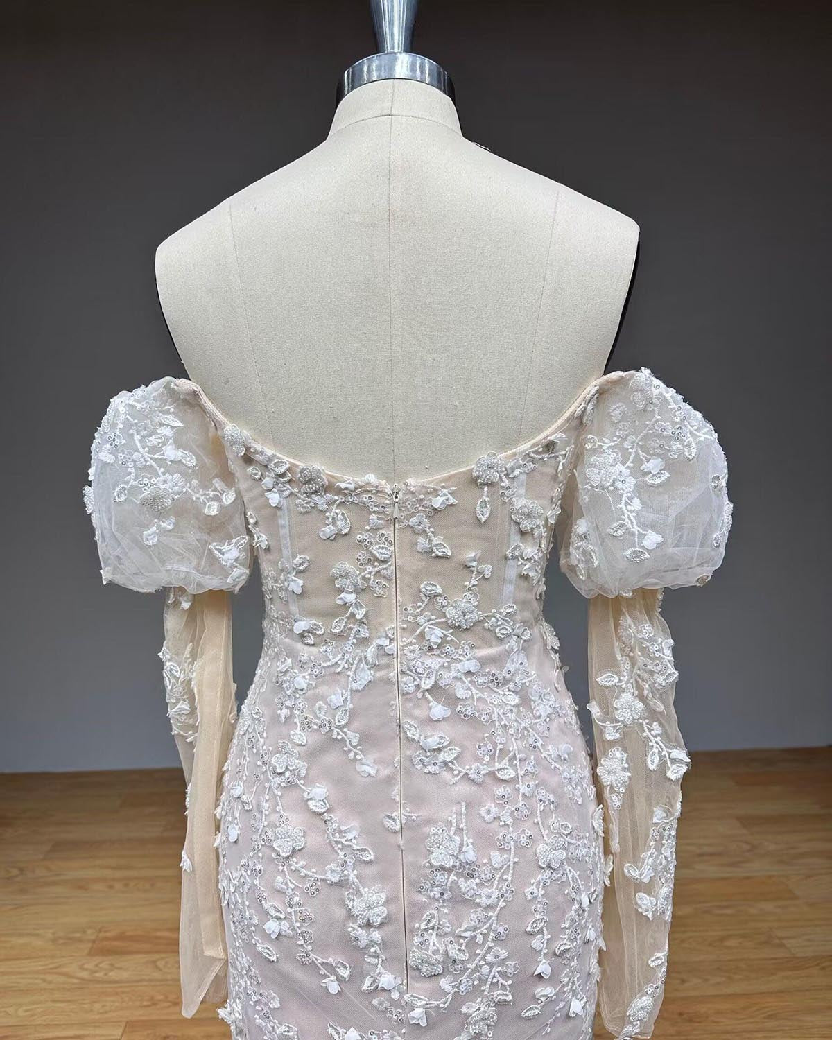 Detailed back close-up view of the vintage bridal gown on a mannequin, highlighting an adjustable ribbon lace-up corset closure over structured boning.
