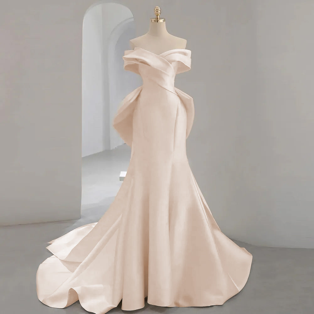 Studio portrait of an off-the-shoulder mermaid wedding dress with short sleeves and a sweetheart neck, presented on a mannequin.