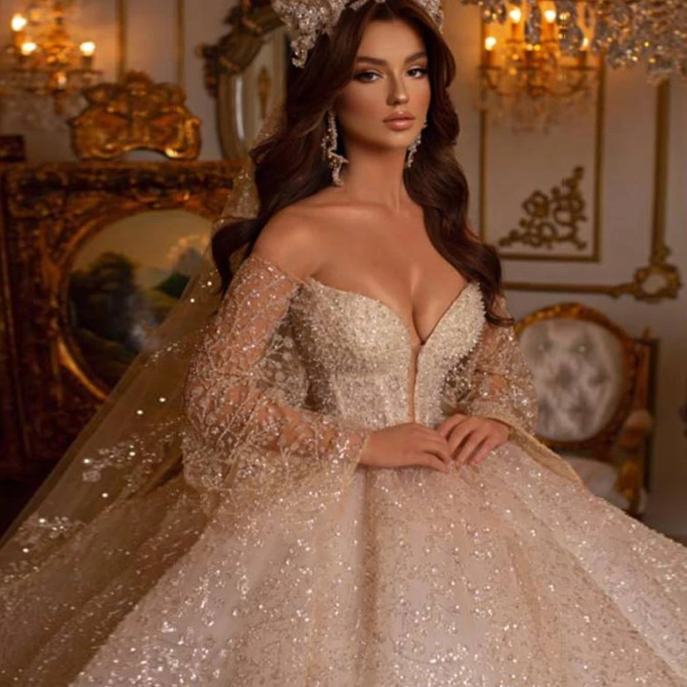 Detailed close-up of an intricate sweetheart bridal bodice highlighting a deep plunge neckline insert and dense, high-end silver rhinestone and sequin beading.