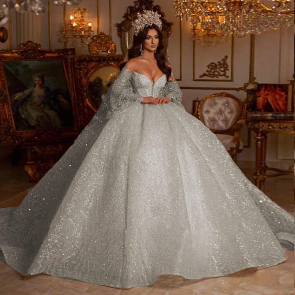 Luxury champagne underlay princess wedding gown with a heavily embellished sweetheart corset bodice and a sweeping silver-glitter overlay skirt.