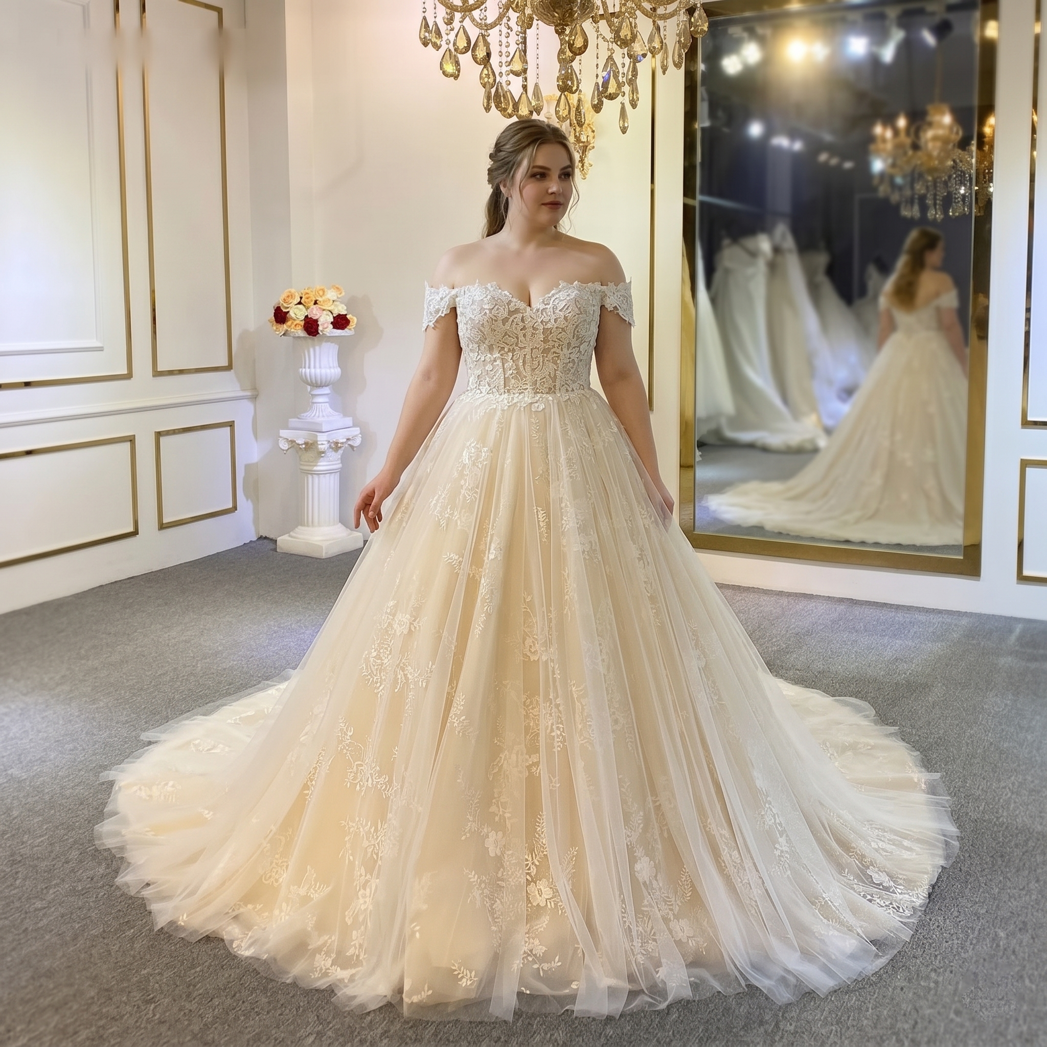 A plus-size bride wearing an elegant, light-colored A-line wedding dress with a lace-embellished bodice, illusion neckline, and a sweeping train.