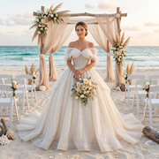 Beautiful bride standing on a beach under a floral arch holding a rose bouquet, wearing a stunning pearl bow glitter ball gown wedding dress featuring an off-shoulder neckline and a sweeping skirt.