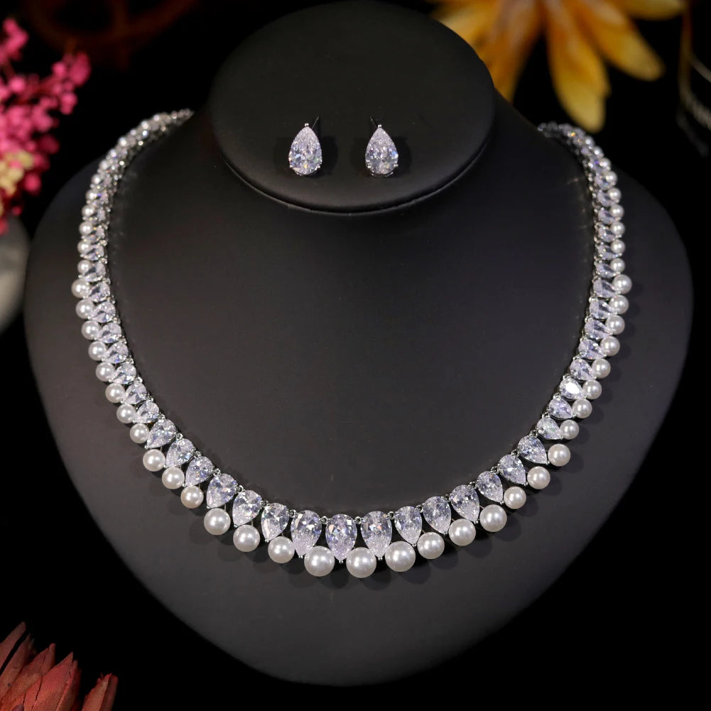 Alternative view of the elegant crystal pearl bridal jewelry set presented on a sleek black mannequin stand.