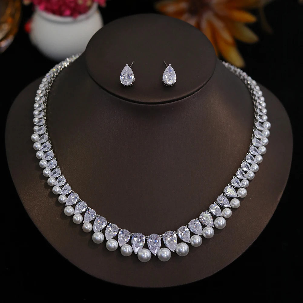 Complete 2-piece luxury cubic zirconia pearl bridal jewelry set beautifully arranged on a professional display mount.