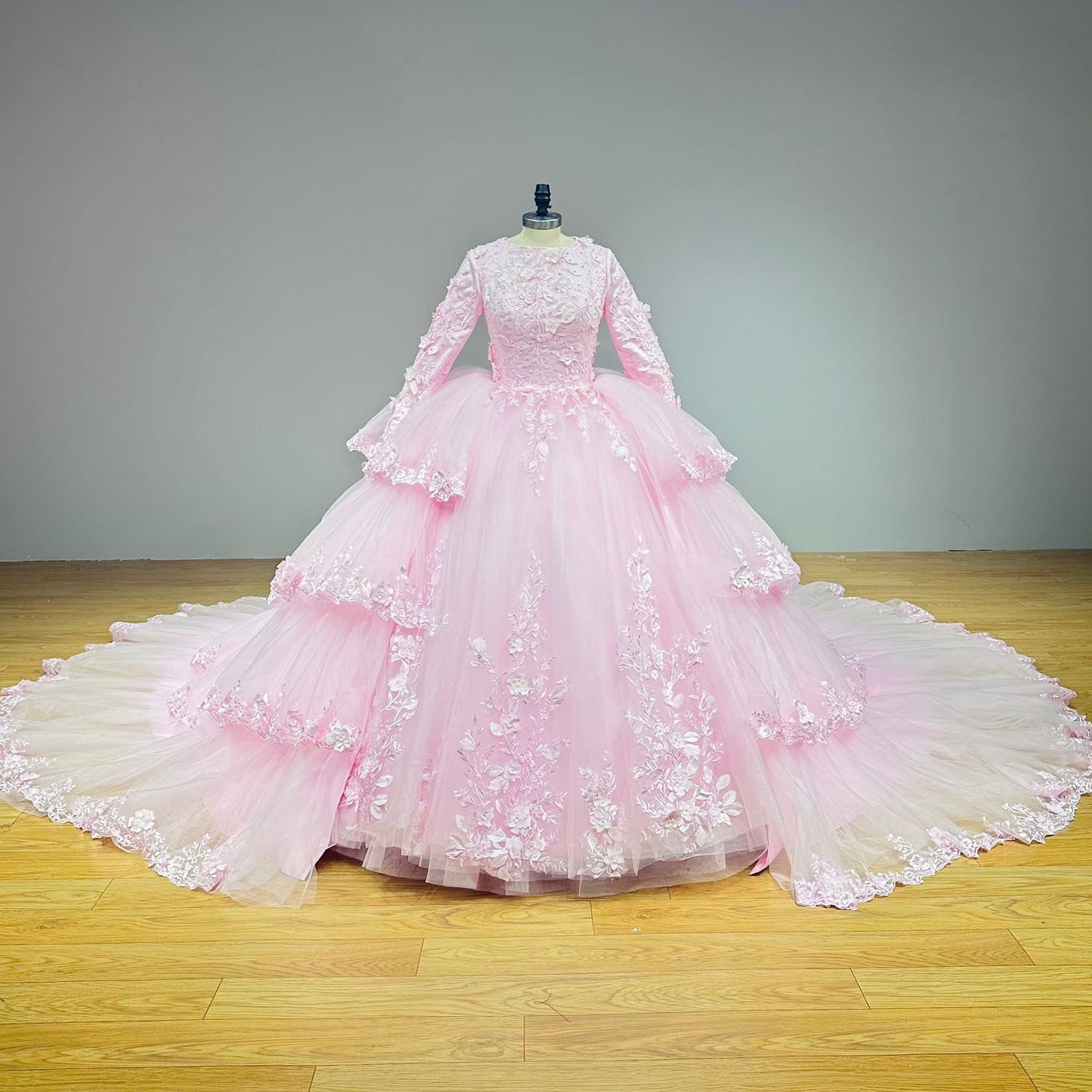 Full front view of the complete pink couture ball gown on a mannequin displaying the grand tiered silhouette with the attached statement overskirt.