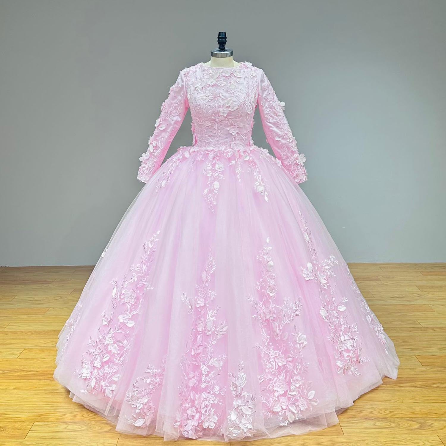 Front view of a pink colored Muslim bridal gown on a mannequin, showcasing the base dress silhouette decorated with cascading vertical lace embroidery.
