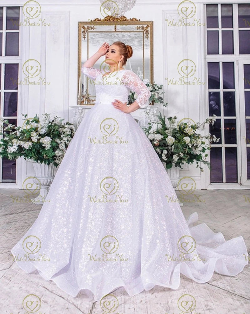Full-length front portrait of the high neck illusion sleeve wedding dress, rendered in a romantic soft blush pink color option for an alternative fairytale bridal look.
