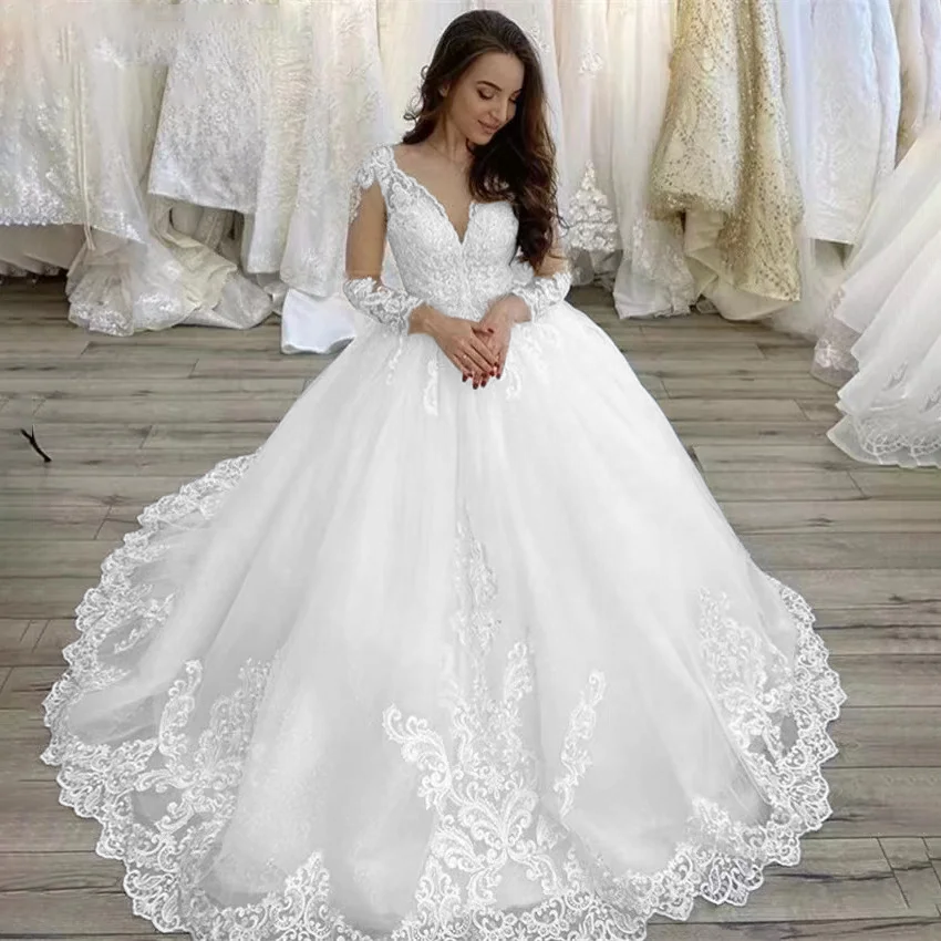 Elegant plus-size wedding dress featuring a V-neckline, full-length lace sleeves, and a grand court train with intricate lace applique details.