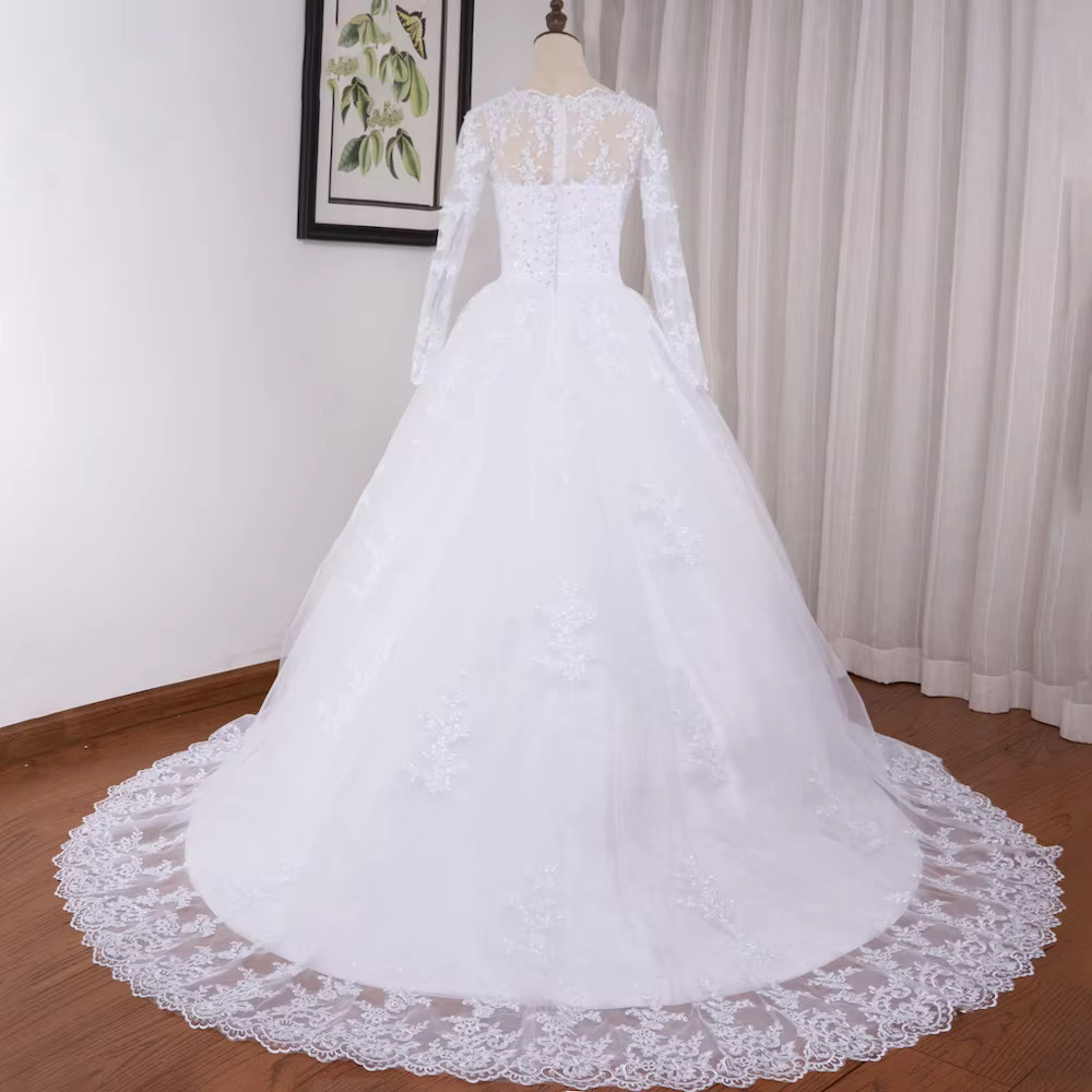 Close-up front portrait focusing on the exquisite floral lace appliques, structured corset boning, and intricate crystal beading across the bodice and cuffs of the long-sleeve wedding dress.