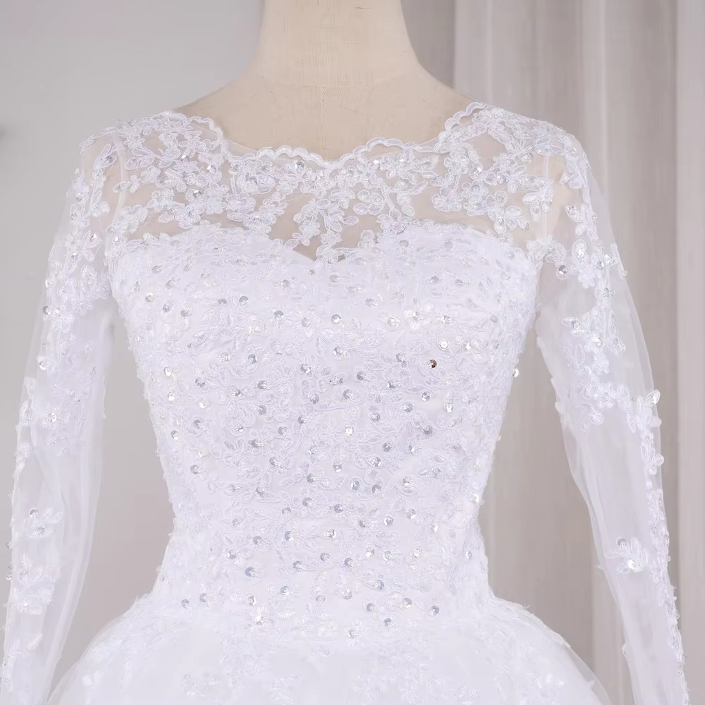 Full-length studio display of the princess lace ball gown bridal dress, featured in a timeless soft white color option highlighting the tiered fullness of the tulle skirt.