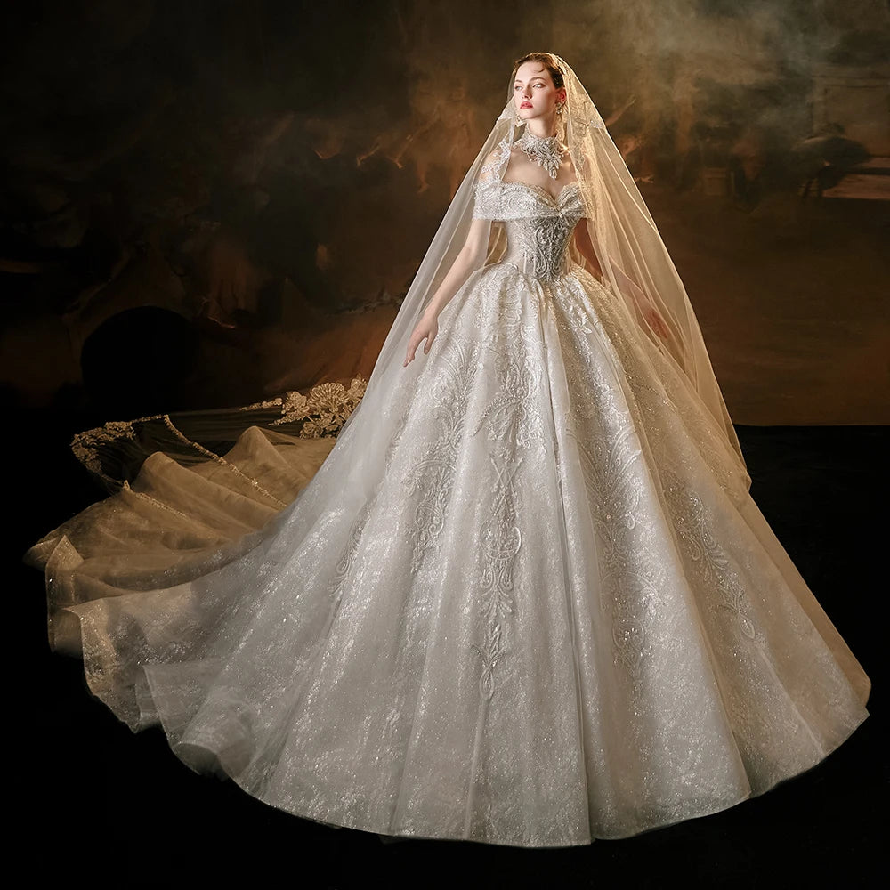 Model wearing a luxury sequin princess ball gown wedding dress with an off-the-shoulder sweetheart neckline, structured beaded bodice, and a statement high-neck crystal collar.