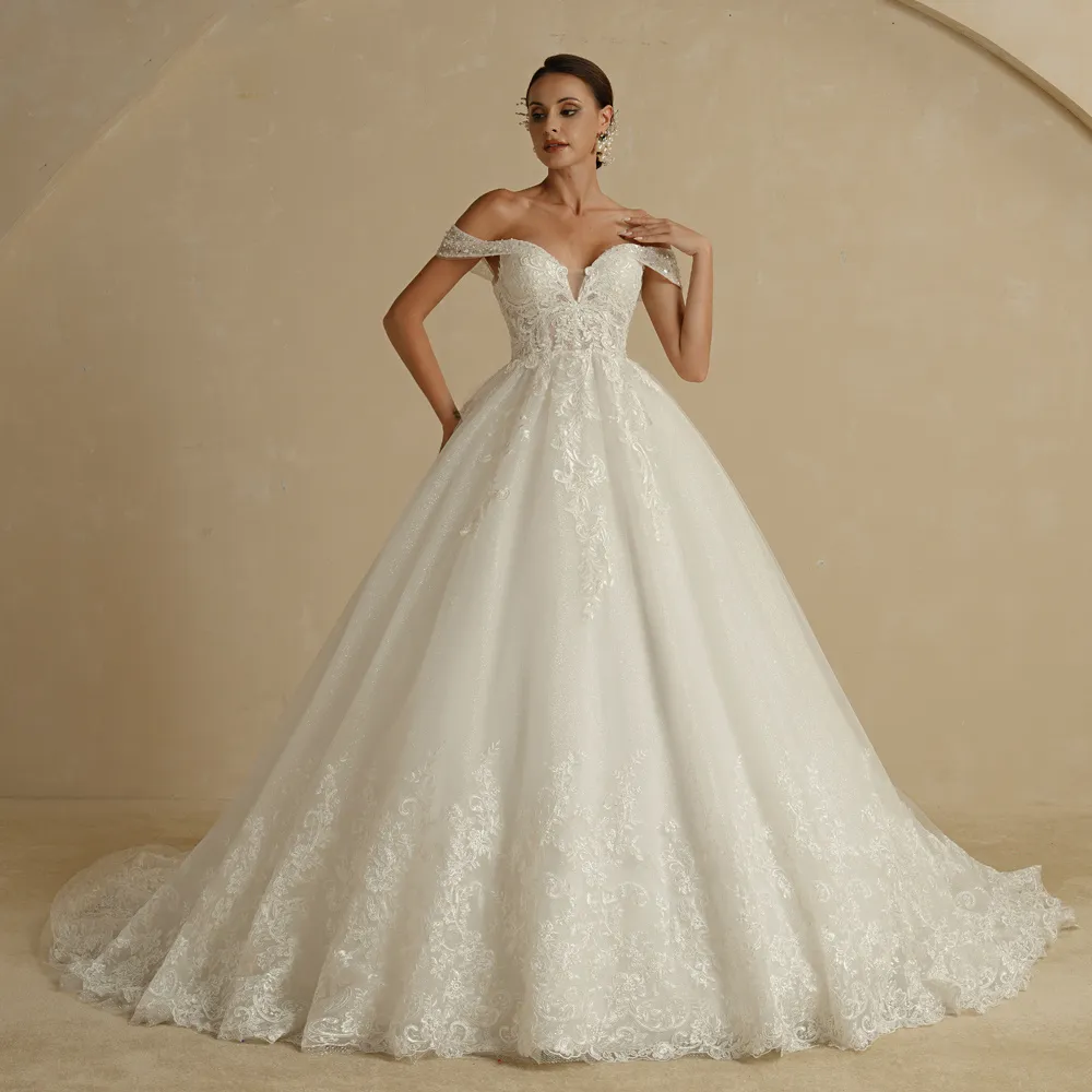 Front view of an elegant, ivory princess ball gown wedding dress, styled with off-shoulder sleeves and a flattering, embroidered A-line bodice.
