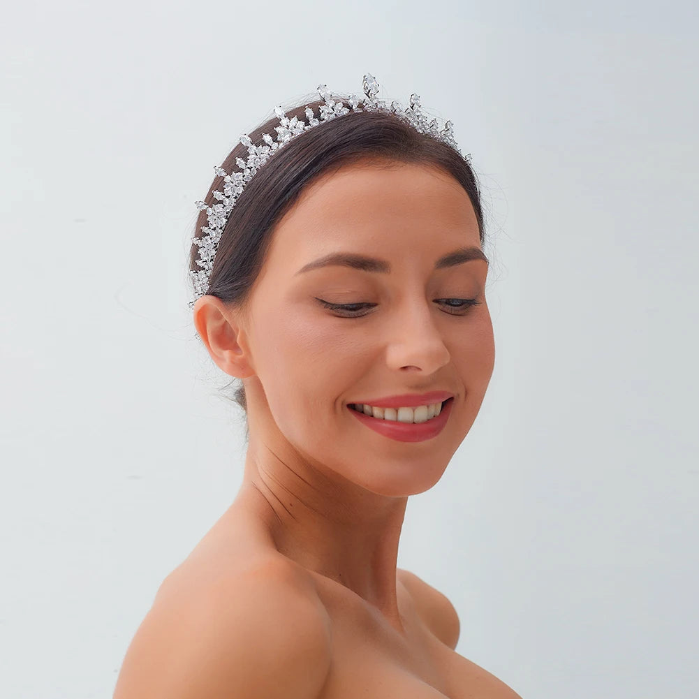 Smiling model wearing an elegant princess tiara headband with brilliant crystal marquise cuts for wedding hair styling