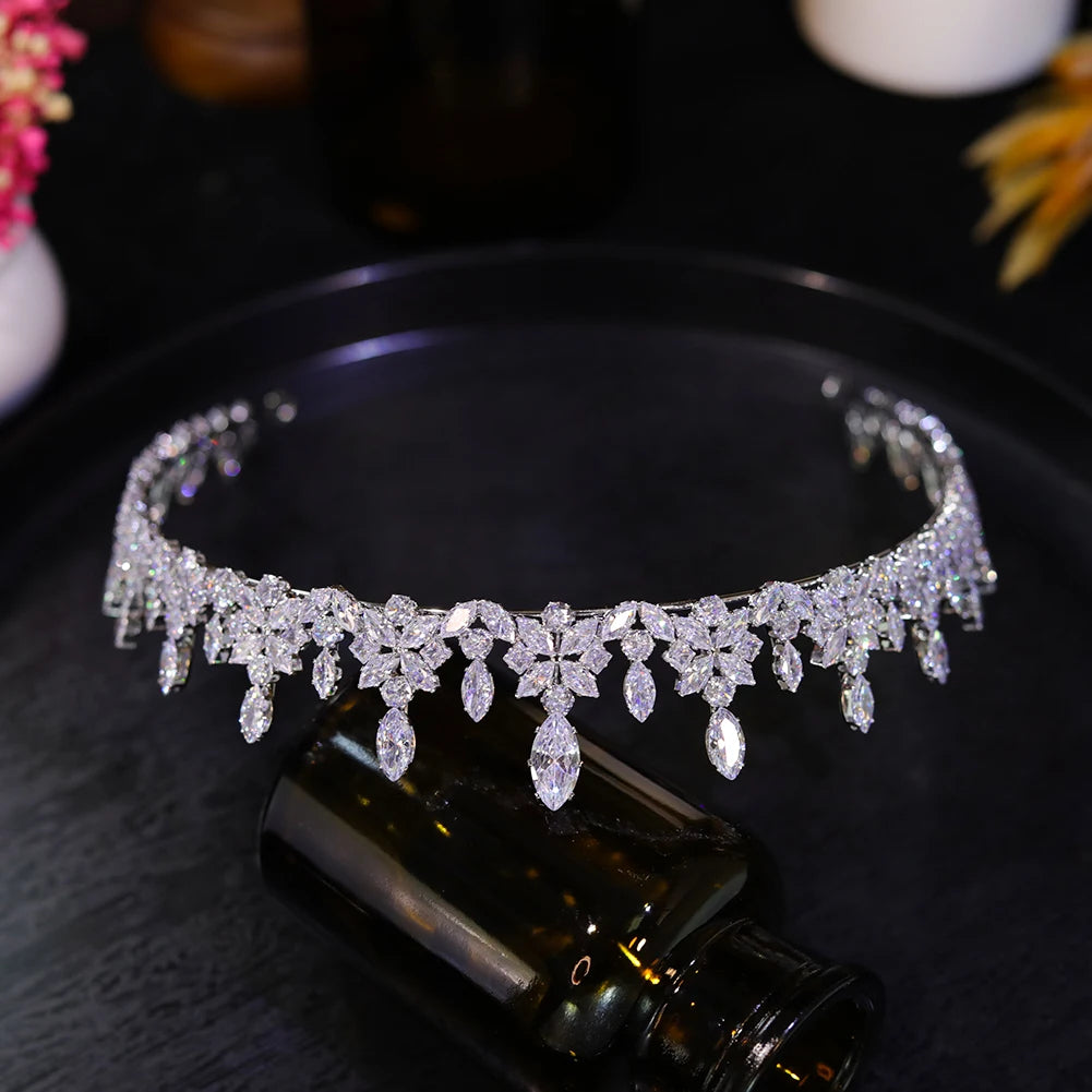 Upside-down view of an intricate rhinestone wedding crown showing the secure metal band and hanging crystal charms