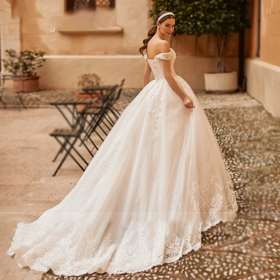 A full-length view of a princess wedding gown featuring a grand train and exquisite embroidery detail.