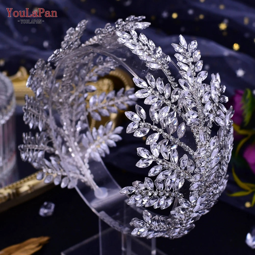High-angle profile shot of a silver wedding hair crown tiara with multi-tiered rows of clear marquise crystals displayed on a clear stand.