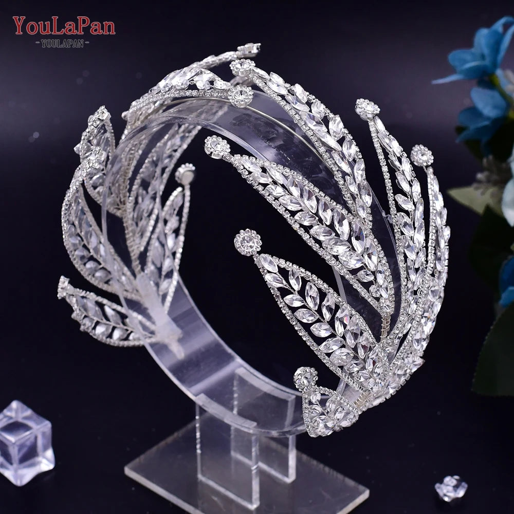 Direct perspective view of a premium silver-plated crystal tiara headpiece featuring sweeping statement leaf branches on an acrylic display.