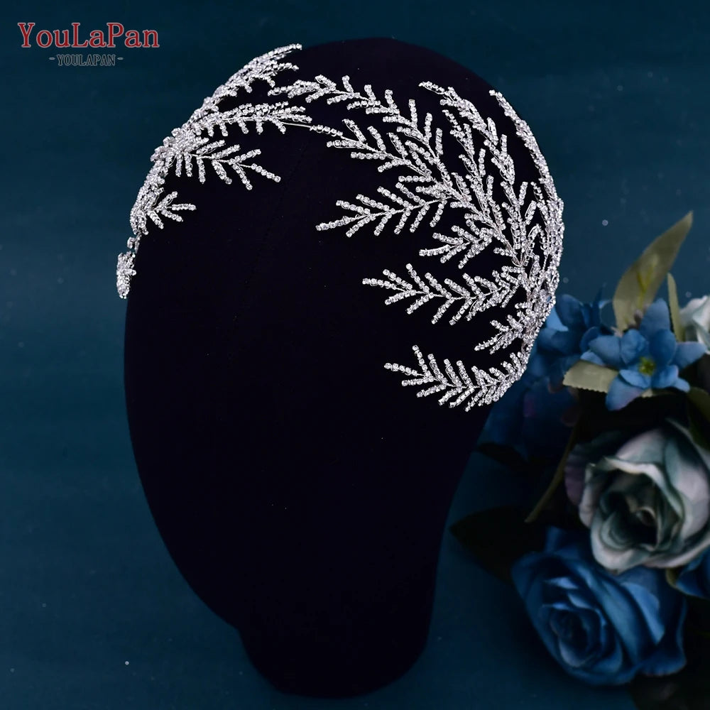 Asymmetric crystal leaf bridal headband with a dense pave rhinestone pine or branch structure showcased on a black mannequin head profile.