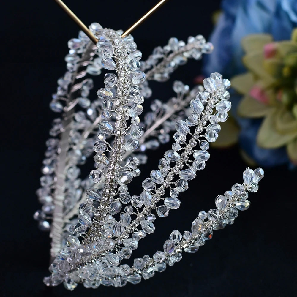 Close-up macro photograph highlighting the detailed gemstone clusters and fine wirework on a glamorous silver wedding hair accessory.