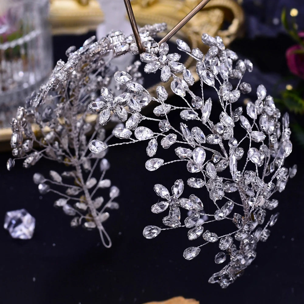Close-up side profile view of a gold-plated option for the rhinestone wedding headpiece tiara featuring sparkling crystal leaf branches.