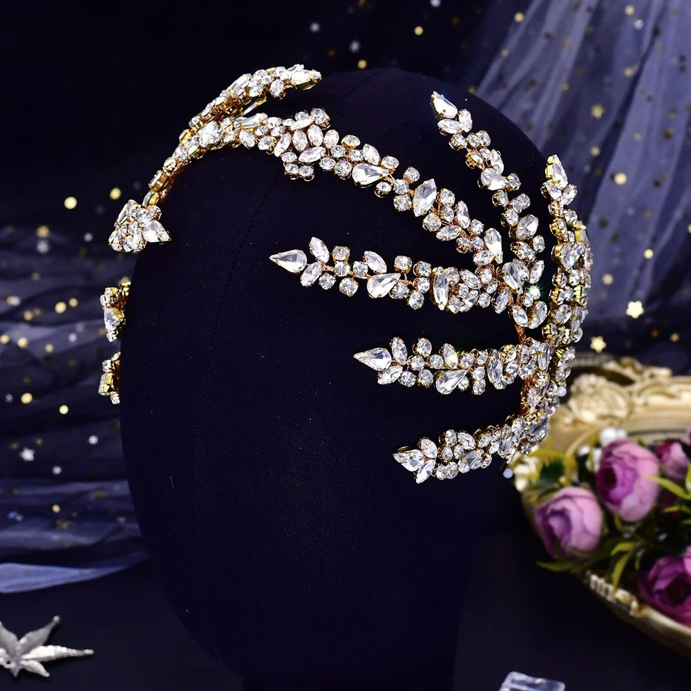 Close-up top view of a luxury gold-plated option for the rhinestone wedding headpiece tiara featuring sparkling crystal leaf branches.