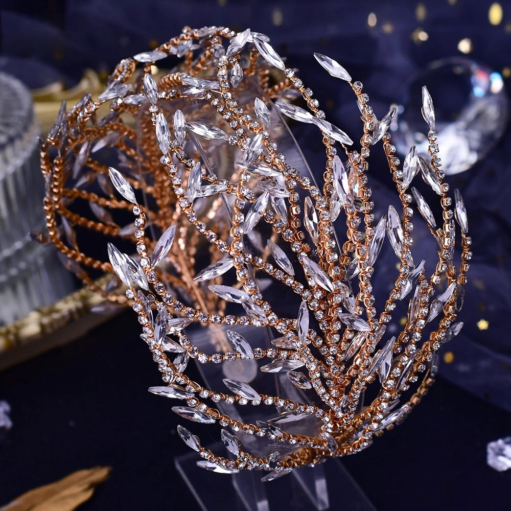 Close-up perspective of a rose gold wedding hair accessory with hand-wired vine branches, clear marquise crystals, and small ivory pearl clusters.