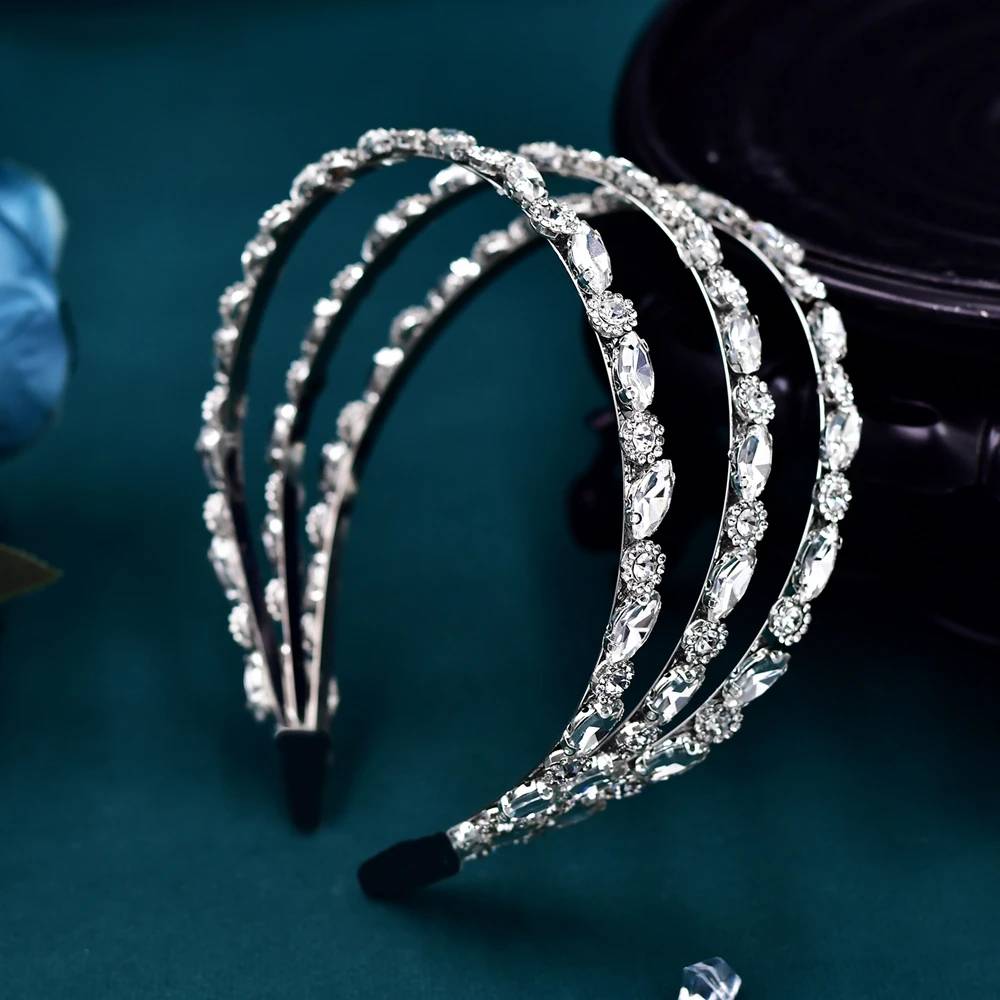 A high-angle close-up highlighting the multi-row structural design of the sparkling silver rhinestone wedding tiara headband.