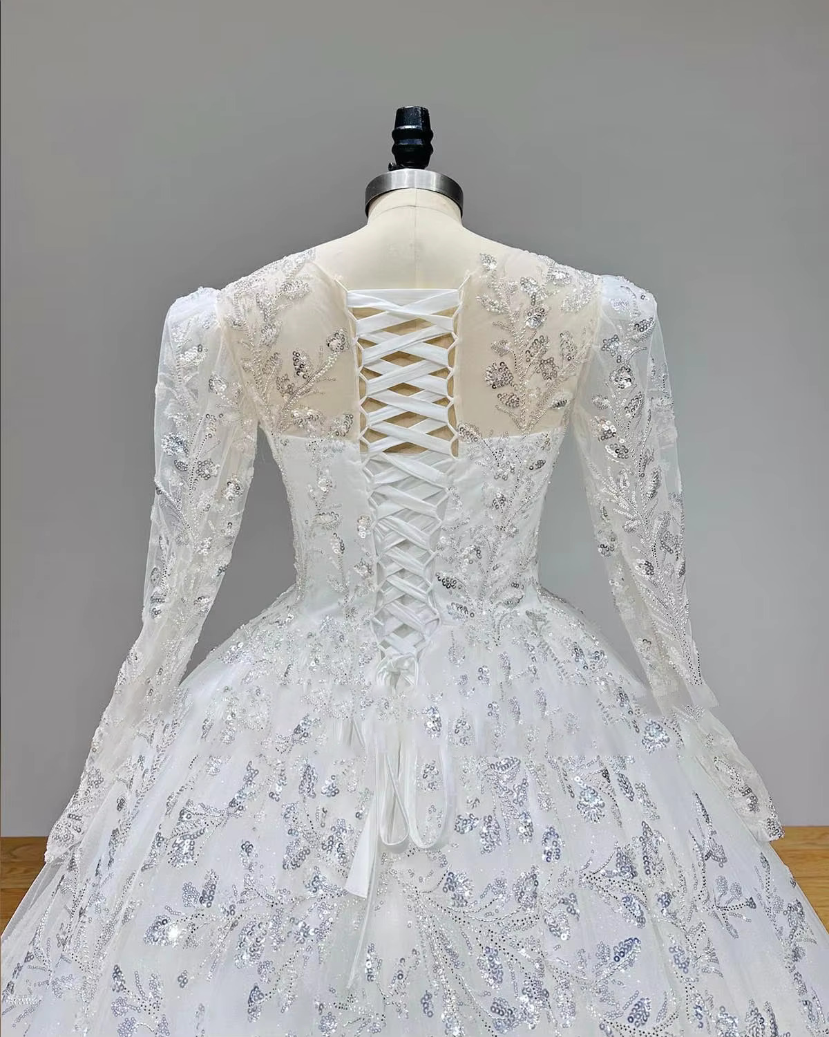 Front display of the off-the-shoulder beaded bridal gown, rendered in a romantic soft blush pink color option for modern alternative fairytale styling.