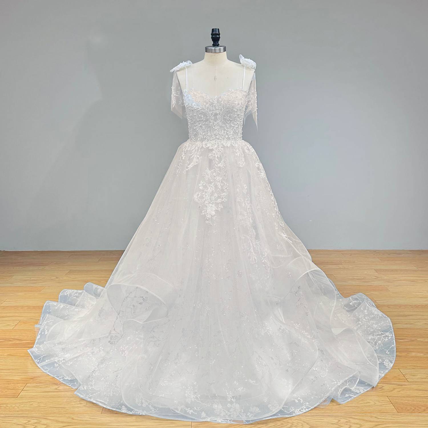 Full-length front studio view of a sleeveless robe marriage sweetheart A-line wedding dress with spaghetti straps, perfectly highlighting the timeless and romantic bridal silhouette.