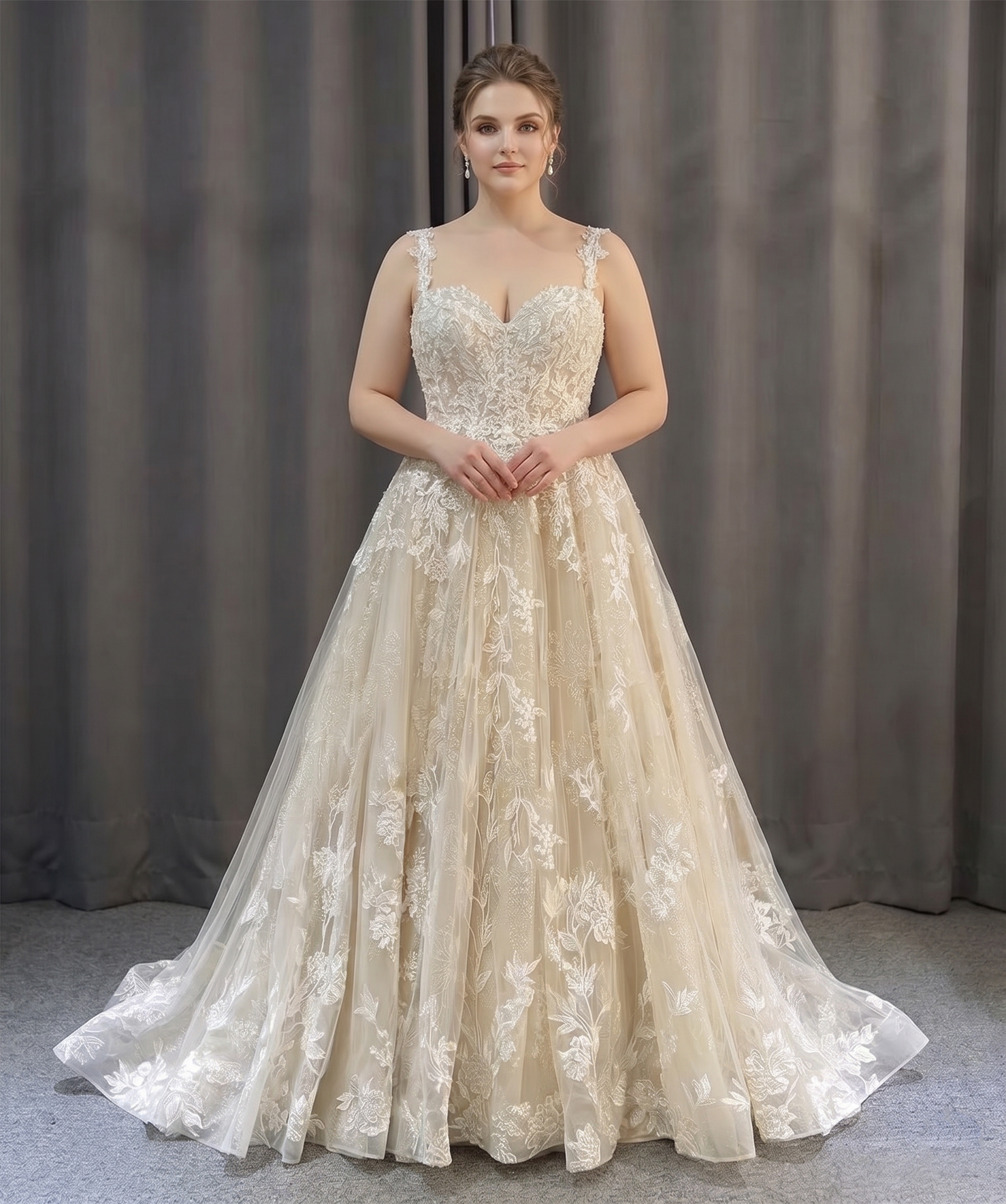 Full-length front view of a plus-size A-line lace bridal gown featuring a flowing skirt on a model.