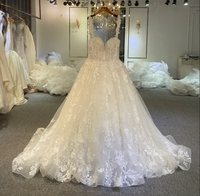 Detailed view of the bodice of the romantic A-line beach wedding dress, emphasizing the delicate straps and lace embroidery.