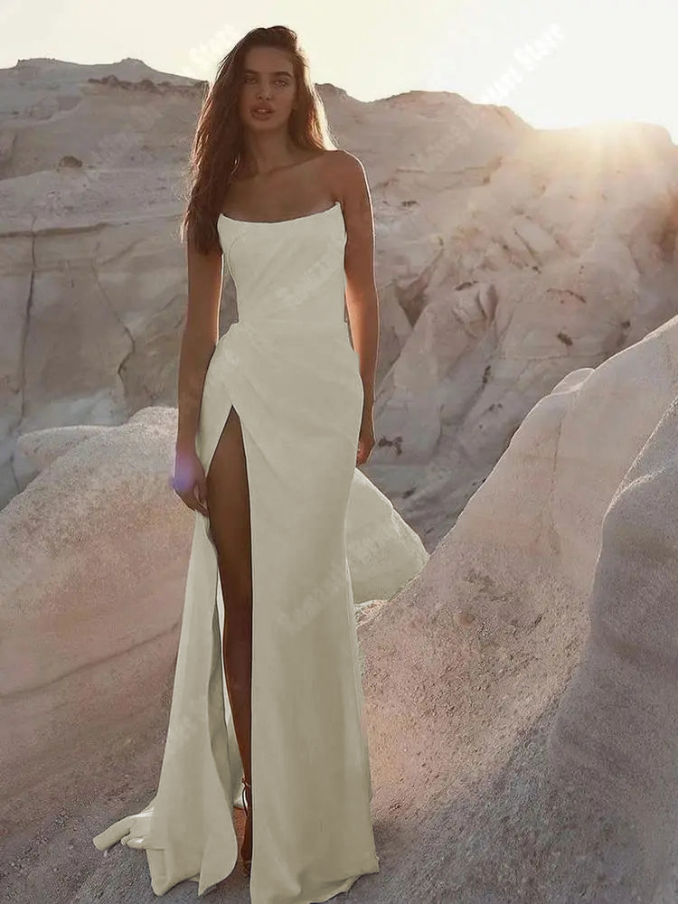 Close-up shot of a romantic satin bridal gown showcasing the tight-fit silhouette, strapless design, and elegant side slit.