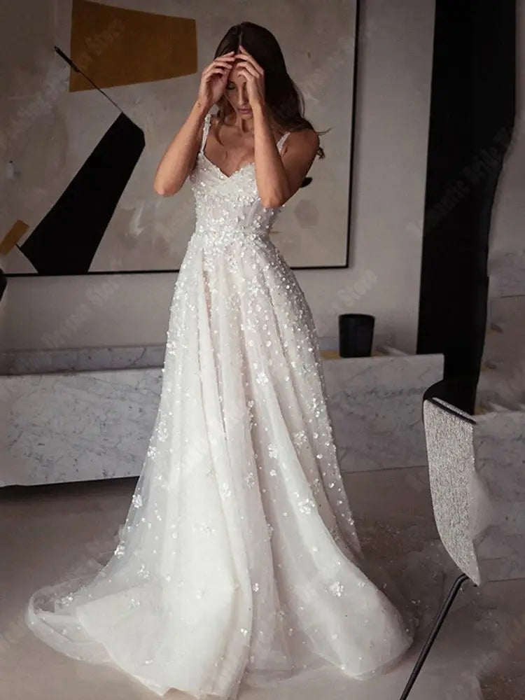 A full-length portrait of a bride posing in a romantic A-line wedding dress with a flattering sleeveless design and soft tulle skirt.