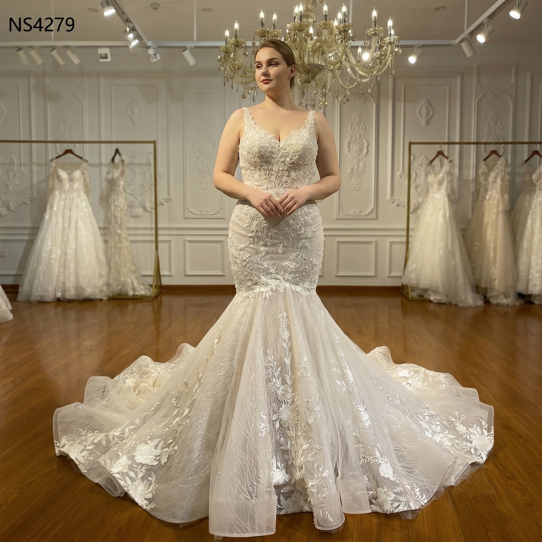 White mermaid bridal gown on a mannequin showcasing intricate 3D floral lace appliqués and a classic sweetheart neckline.