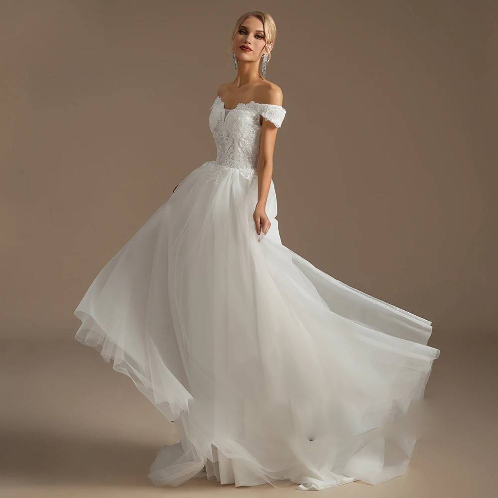 Front view of a romantic 3D floral applique wedding dress on a mannequin, highlighting the high-neck illusion bodice and cascading layered princess skirt.
