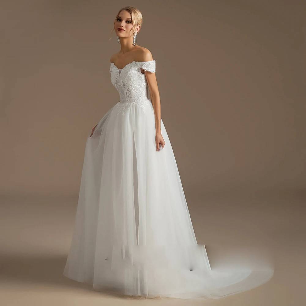 Three-quarter side angle of a dreamy princess wedding dress on a mannequin, detailing the immense volume and cascading tiered ruffles of the floral organza skirt.