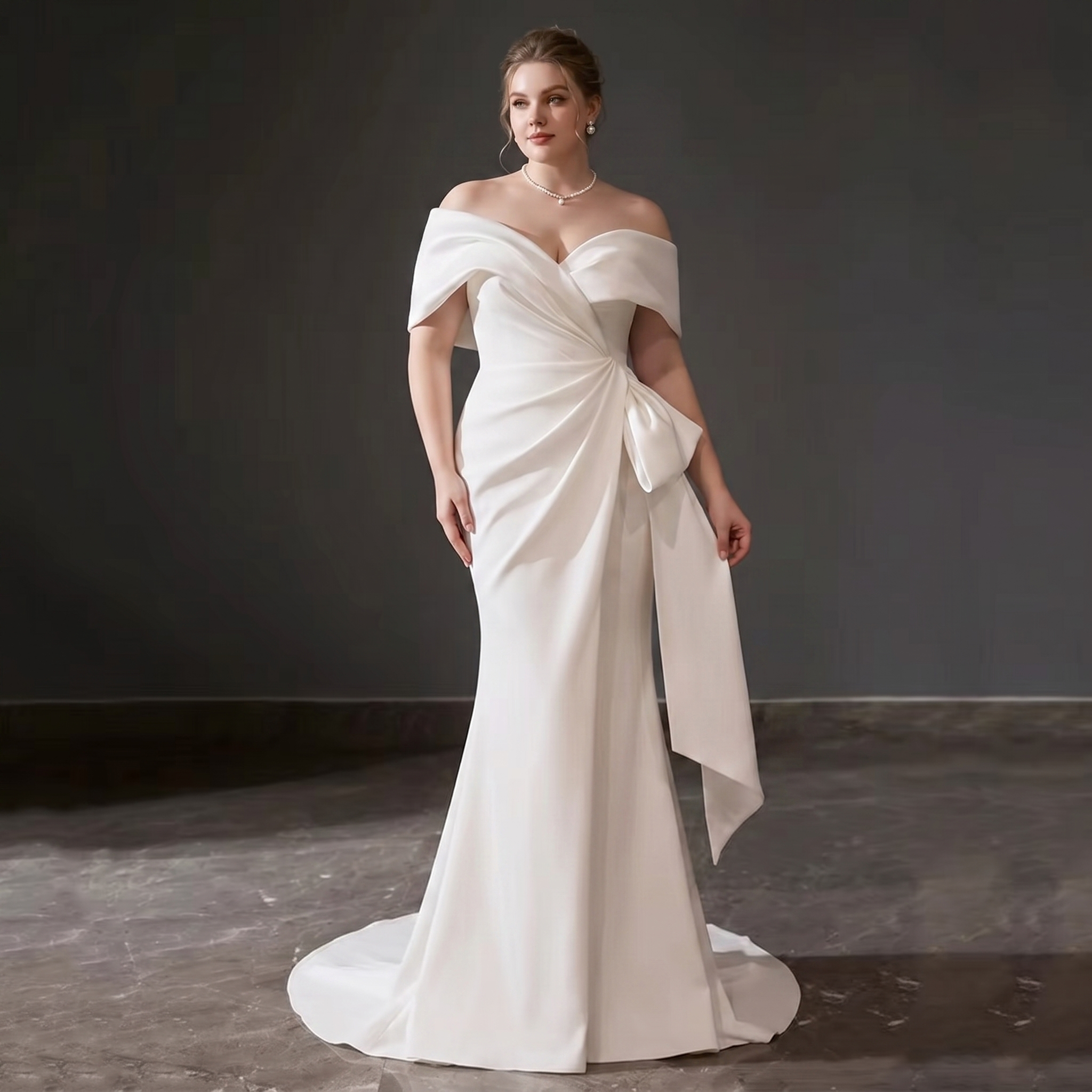 Rear view of a structured satin bridal gown showing a low open V-back, a clean fitted mermaid silhouette, and an elegant pooling satin train.