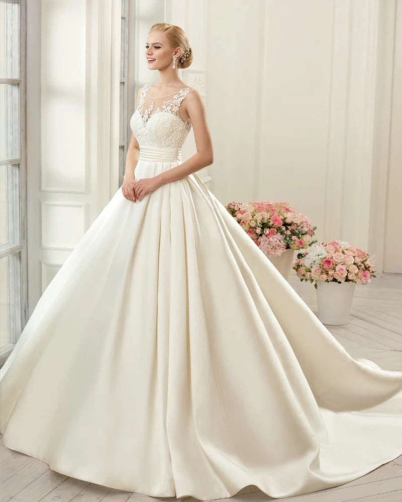 A simple A-line bridal dress with a satin skirt, sweetheart neckline, and sophisticated lace detailing.
