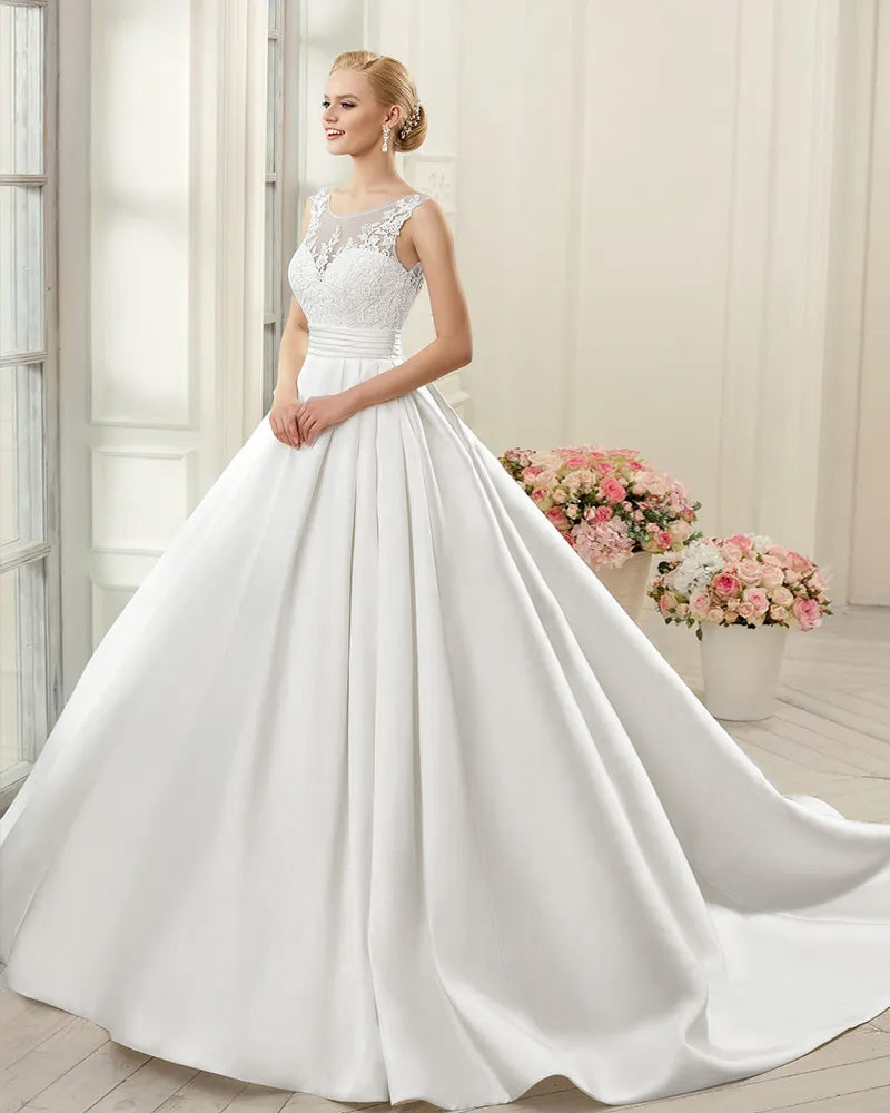 Sophisticated back view of a satin A-line wedding gown with an open-back style and elegant button accents.