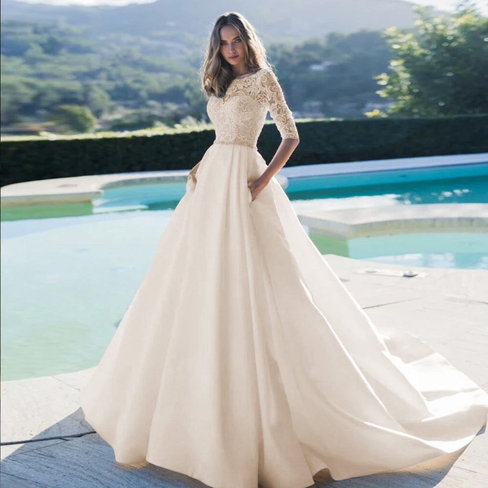 A stunning A-line bridal gown with a delicate lace bodice, scoop neckline, and a classic court train, perfect for a luxury wedding.