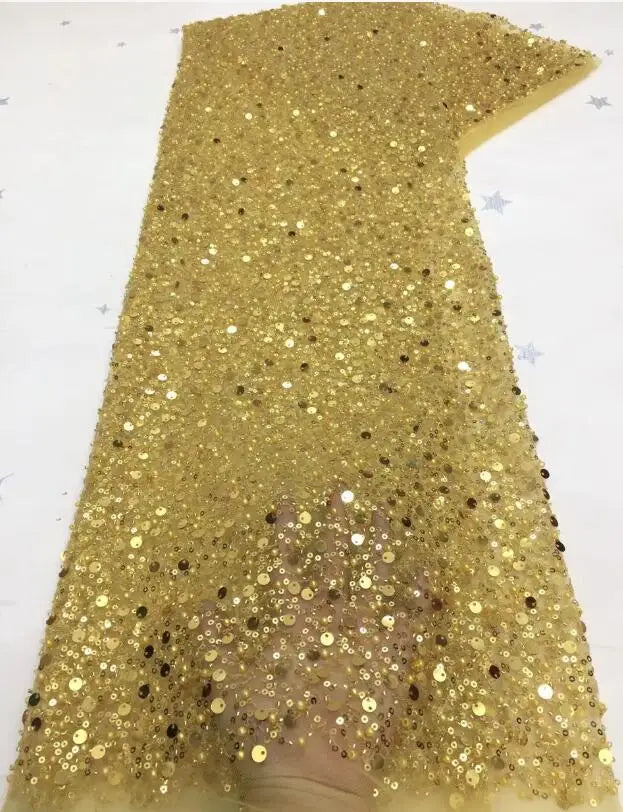 A collection of luxury sequin and bead-embellished fabric swatches in multiple colors for bridal gown customization.