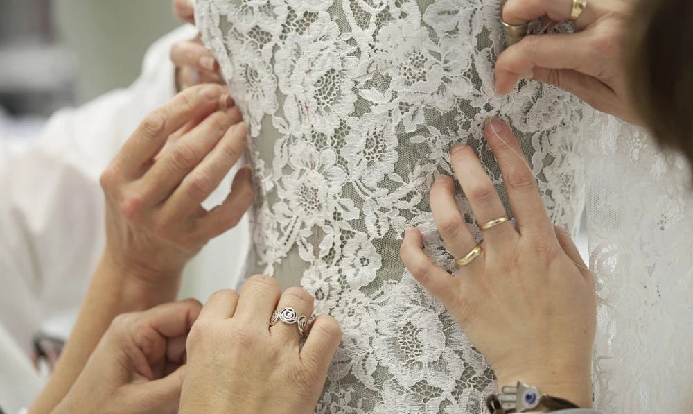A princess-style wedding gown featuring an off-shoulder sweetheart bodice, sparkling glitter skirt, and delicate lace applique detailing.
