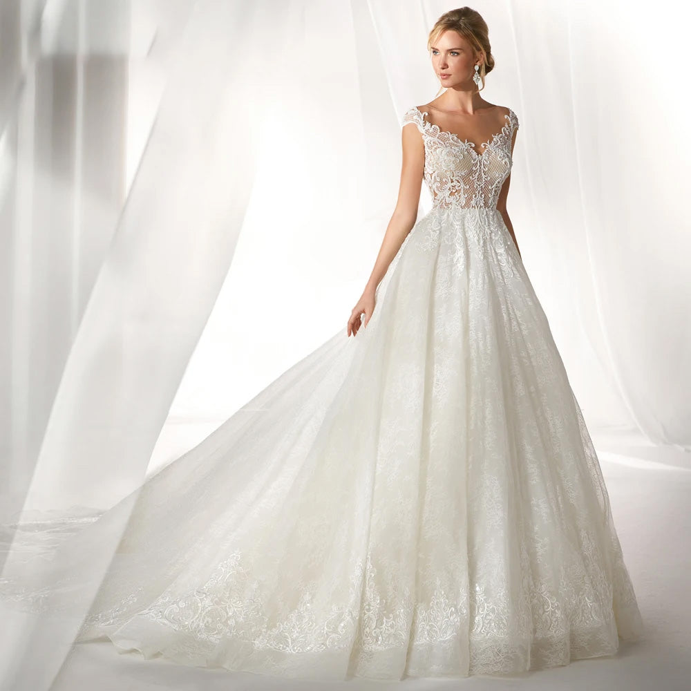 Full-length view of an exquisite A-line princess bridal gown featuring long lace sleeves, a flattering fitted bodice, and a grand, voluminous skirt.