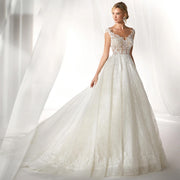 Full-length view of an exquisite A-line princess bridal gown featuring long lace sleeves, a flattering fitted bodice, and a grand, voluminous skirt.