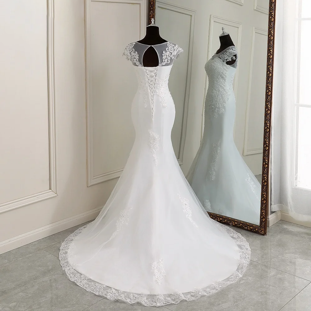 A close-up front view of the lace cap sleeves and bodice of the mermaid wedding dress, featuring intricate floral patterns and beadwork.