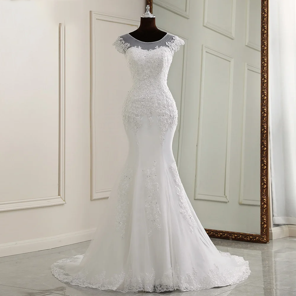 A mannequin display of the complete cap-sleeve mermaid bridal gown, showing the form-fitting silhouette and refined lace placement.
