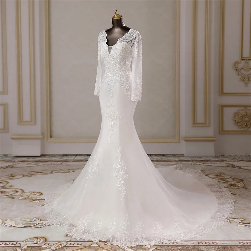 Side profile view of a long-sleeved mermaid wedding dress on a mannequin, showcasing the fitted silhouette and elegant lace appliques.