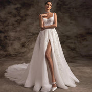 Model wearing a sexy A-line vintage wedding dress with a high leg slit, spaghetti straps, and shimmering court train.