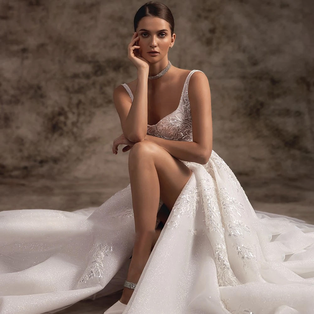 Elegant bridal gown featuring a thigh-high slit, spaghetti strap sweetheart bodice, and vintage-inspired lace.